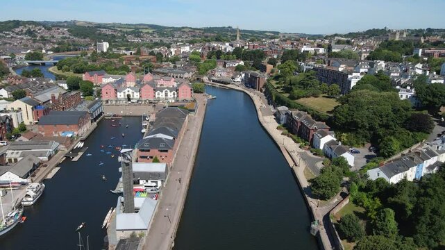 Aerial footage of Exeter Quay, Devon, England, showing the historic waterfront along the River Exe with charming buildings, boats, and vibrant surroundings. Ideal for travel, urban, and historic uses.
