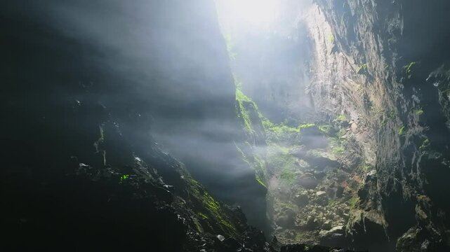 Drone footage flying backward through the cloud at Doline 1 in Hang Son Doong, Vietnam