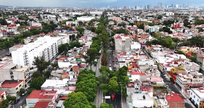 Drone flight over the "Misterios" Causeway away from the area of ​​the Basilica of Guadalupe, towards the center of Mexico City during a summer afternoon