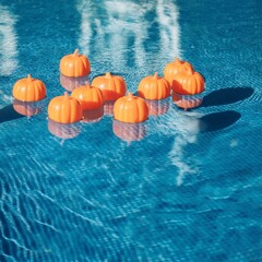Plastic Pumpkins Floating in a Pool Party Idea