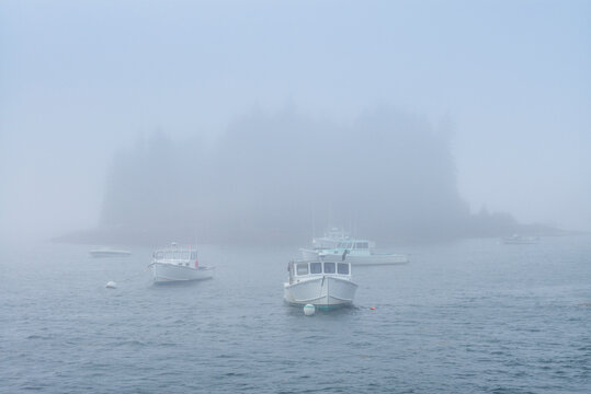 USA, Maine, Port Clyde. Port Clyde Harbor, boats in the fog.