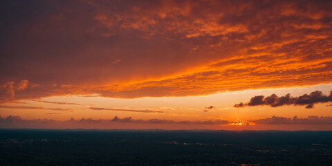 Obraz premium Bright Orange Sky at Sunset Over a Cityscape