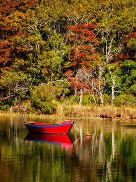 USA, Massachusetts, Cape Cod, Red dory on Herring River