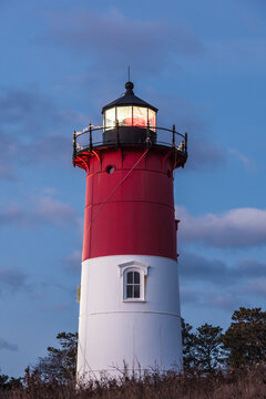 USA, Massachusetts, Cape Cod, Eastham. Nauset Light with Christmas wreath at dawn.