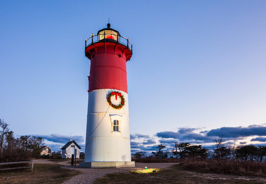 USA, Massachusetts, Cape Cod, Eastham. Nauset Light with Christmas wreath at dawn.