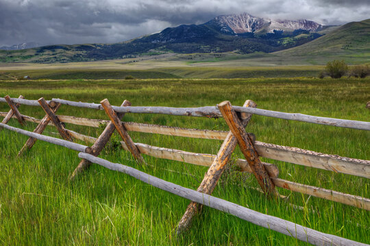 USA, Montana. Split rail fence and Rocky Mountains. 
