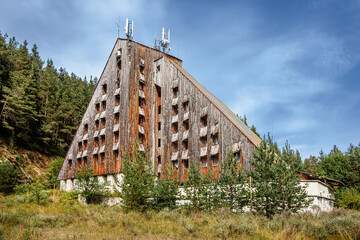 An abandoned Academica hut in pine forest. Closed old mountain hotel in Pirin national park,...