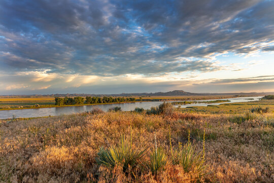 Sunrise and clouds over the Yellowstone River at the confluence with the Powder River near Terry, Montana, USA