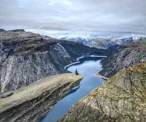 Stunning view of Trolltunga, a famous rock formation in Norway, overlooking a majestic fjord.