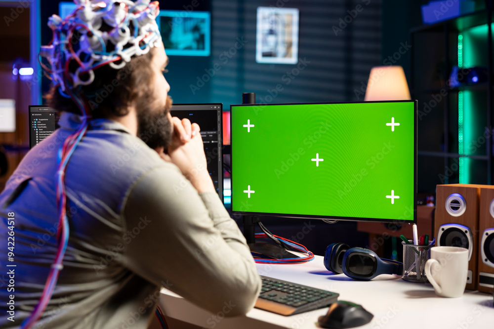 Poster neuroscientist using eeg headset to upload his mind into green screen computer, attaining immortalit