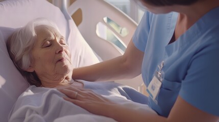 Obraz premium A young female nurse comforts an elderly woman in a hospital bed.