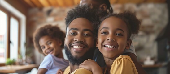 In a warm and cozy living room, a happy African American family savors moments of love, laughter, and togetherness, reinforcing their bond through joy and affection. They cherish family time together