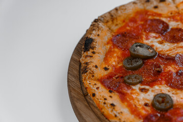 Pizza with salami and prosciutto. Meat pizza with cheese and jalapeno pepper