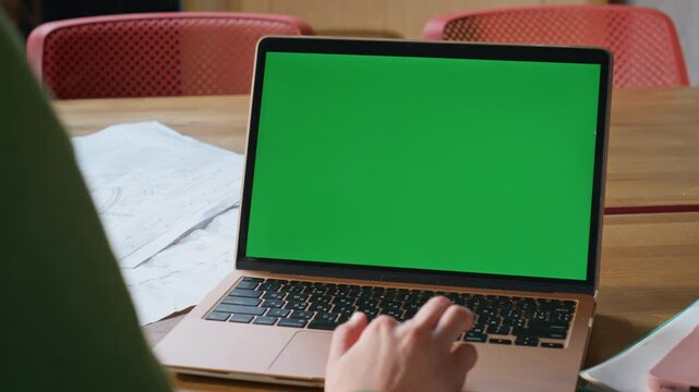 Employee using greenscreen touchpad on computer at remote workplace closeup