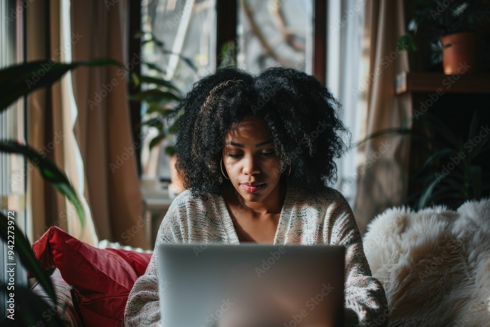 Poster a person sitting on a couch using a laptop, suitable for remote work or online communication