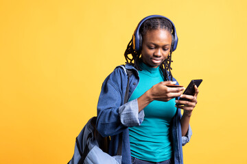 Woman adding payment method on website, enjoying sales period, isolated over studio background. Girl doing internet shopping, typing credit card information on smartphone