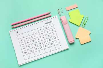 Calendar with office stationery on turquoise background