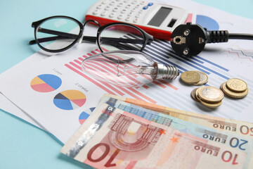 Electric power plug with light bulb and money on blue background