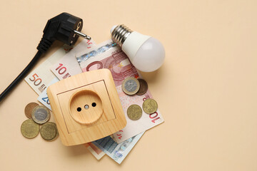 Electric power plug and socket with light bulb and money on beige background