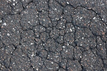 Cracked Asphalt Closeup with Imbedded Stones