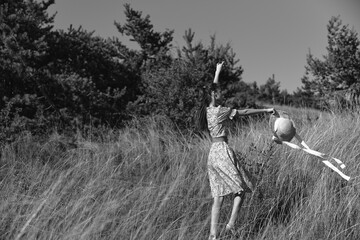 Girl playing with kite in beautiful field of nature, entertainment and fun in outdoor adventure