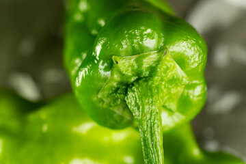 A bright green chili pepper from a closeup perspective.
