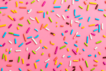 trendy pattern of colorful sprinkles for background of design banner, poster, flyer, card, postcard, cover, brochure over pink