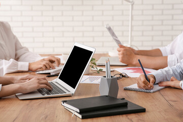 Business team with laptop during meeting in office, closeup