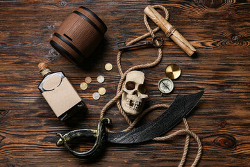 Pirate's items on wooden background, top view