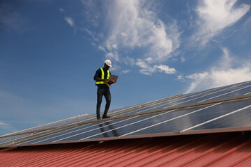 The black male Solar energy systems engineer performs analysis of solar panels  at the solar farm