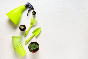 Gardening tools with shovel, rake, spray bottle and peat pots on white background. Top view