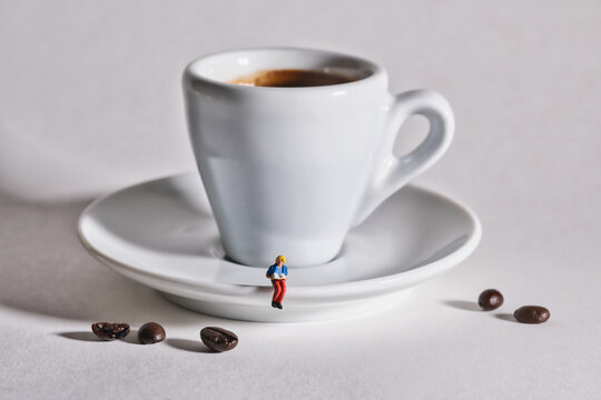A woman reads a book with a cup of coffee