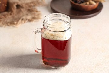 Mason jar of fresh kvass on white background