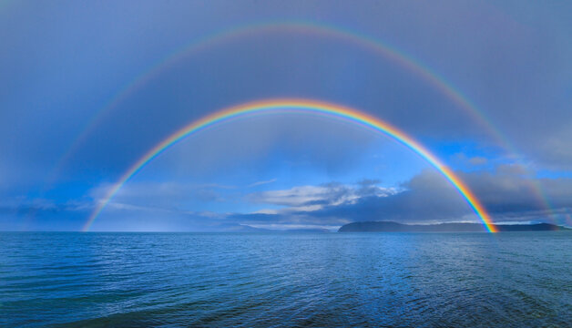 USA, Washington State, Seabeck. Panoramic of double rainbow over Hood Canal.