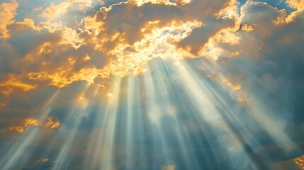 Fototapeta premium Sunbeams filter through gaps in the clouds, creating radiant shafts of light in the sky.