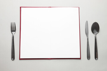 Hardcover notebook with empty sheets for menu design and cutlery on light grey table, flat lay