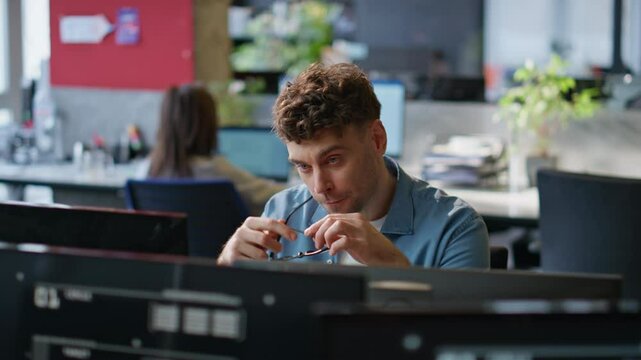 Office manager feeling tired looking computer at corporate workplace closeup