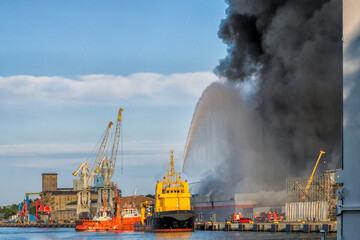 A fire in a warehouse in which a toy wholesaler caught fire. The fire was extinguished by firefighting vessels and fire brigade units, Port of Gdansk, Gdansk, Poland. date of destruction July 14, 2024