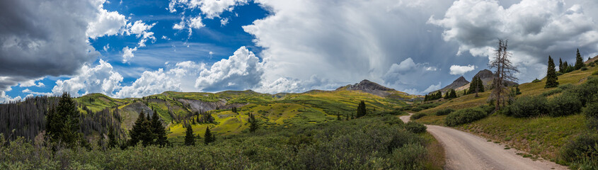mountain tundra panorama with dirt road and dramatic lighting