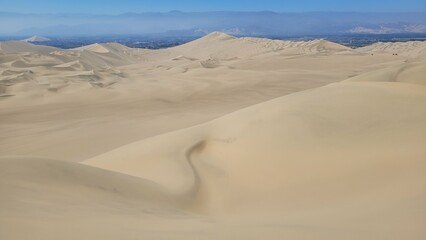Sand dunes desert city Peru