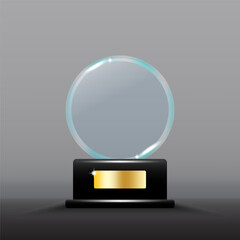 Glass trophy award. Transparent circular shape with shining highlights. Black base with gold plate.