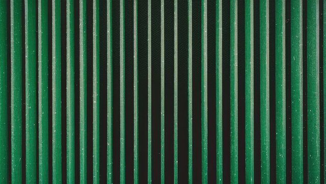  Abstract green vertical lines texture on a dark background with grainy noise