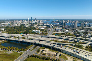 Aerial view of Jacksonville city with high office buildings and american freeway intersection with...