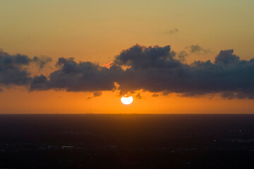 Amazing evening skyscape. Sunset sky with bright colorful clouds over dark landscape