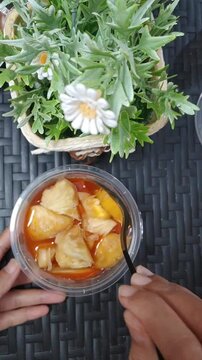 fresh and healthy dish in the form of fruit salad in a jar, typical of Indonesia, is called fruit pickled or Asinan, consisting of pineapple, mango, kedondong, has a spicy, sweet, sour and salty snack