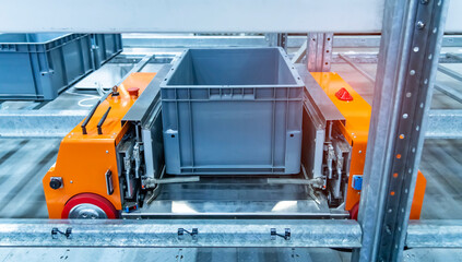 plastic boxes in the cells of the automated warehouse. Metal construction warehouse shelving