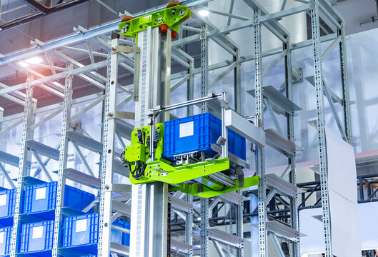 plastic boxes in the cells of the automated warehouse. Metal construction warehouse shelving