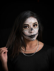 Woman with Day of the Dead Makeup Adjusting Her Hair