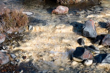 Water flows over creamy white rocks in The Silica Rapids