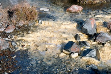 Water flows over creamy white rocks in The Silica Rapids